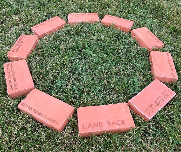 a circle of bricks on green grass