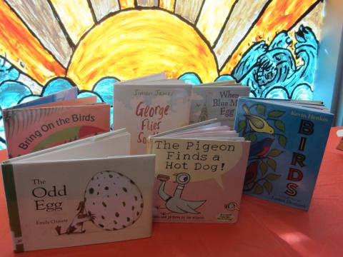 Books on table in front of sunny window