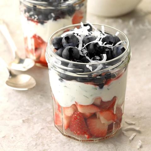 Picture of a mason jar with yoghurt or cream, separated by layers of fruit