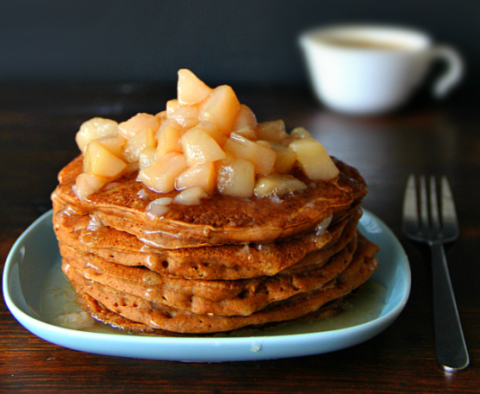 Picture of a shortstack of buttered pancakes, topped with sweetly crushed apples drizzled in butter and syrup.