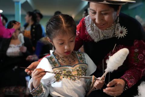 Indigenous girl and woman spinning yarn/thread.