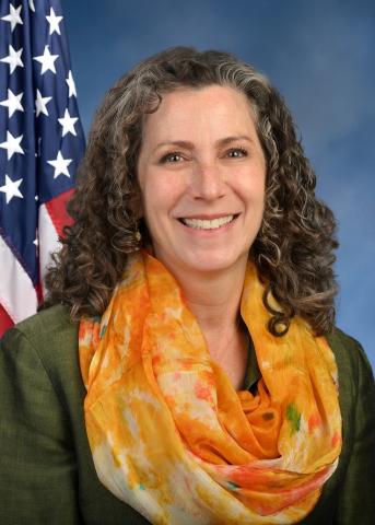 Dana Levenberg.  Orange scarf and blue background with the American Flag.