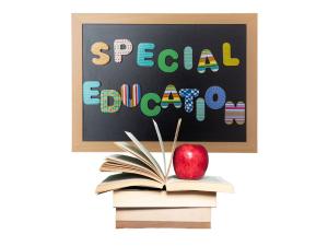 Rectangular blackboar with special education written in rainbow bubble letters with a stack of books under the blackboard.  there is a red apple on to of the books.