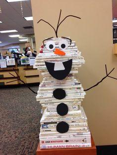 a stack of books wrapped in white paper and decorated to look like Olaf from the movie Frozen.