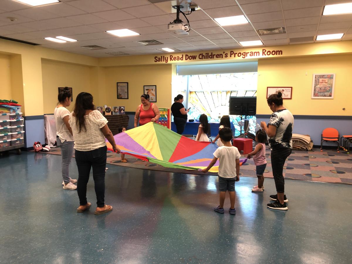 Children and adults playing with a parachute