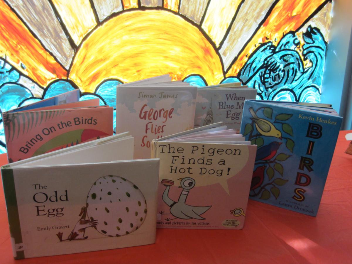 Books on table in front of sunny window