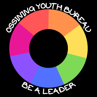 The image shows the Youth Bureau logo.  The background is a black square and there is a life safer type circle in the colors of the rainbow.  The words Ossining Youth Bureau and Be a Leader  are in white  around the circle.