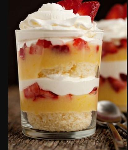 delectable layers of soft cake nestled in between sweet clouds of cream and berries