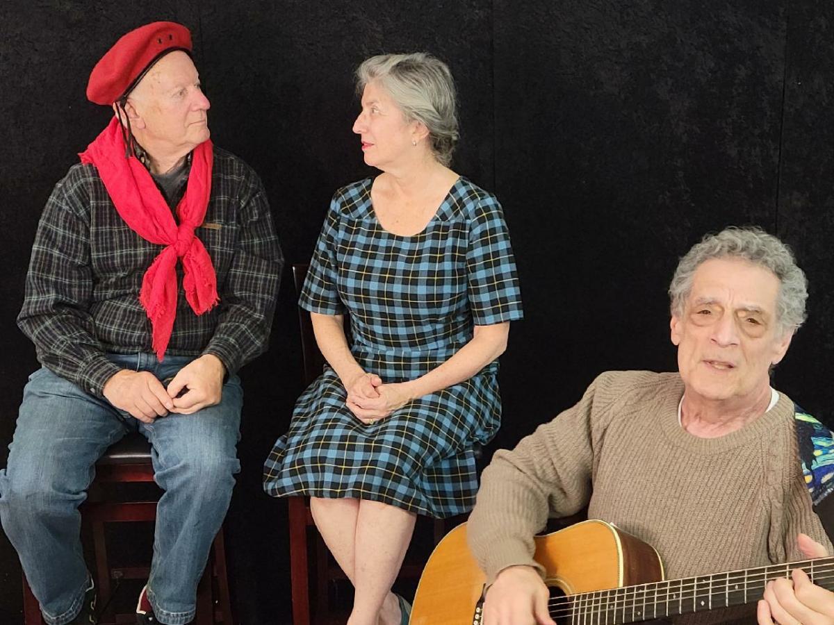 Three people performing in theater production.