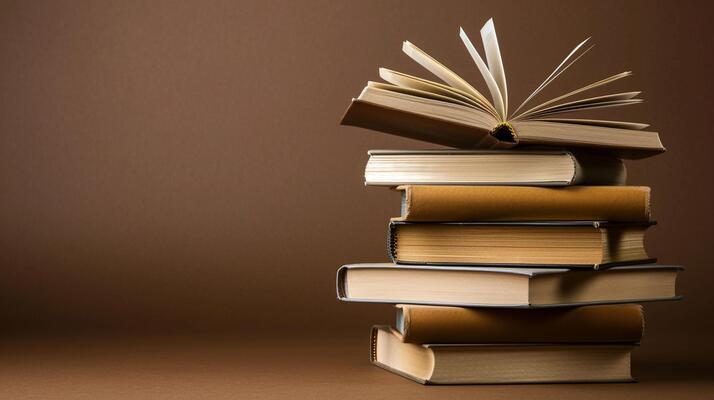 Stack of books with a brown background.